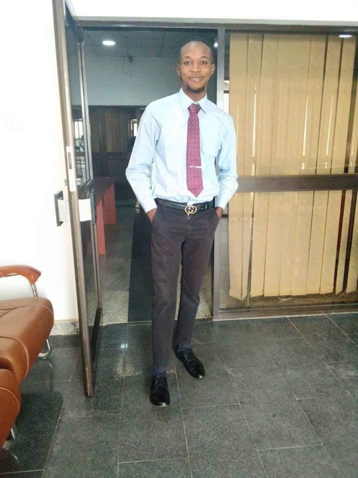 Standing indoors in formal attire