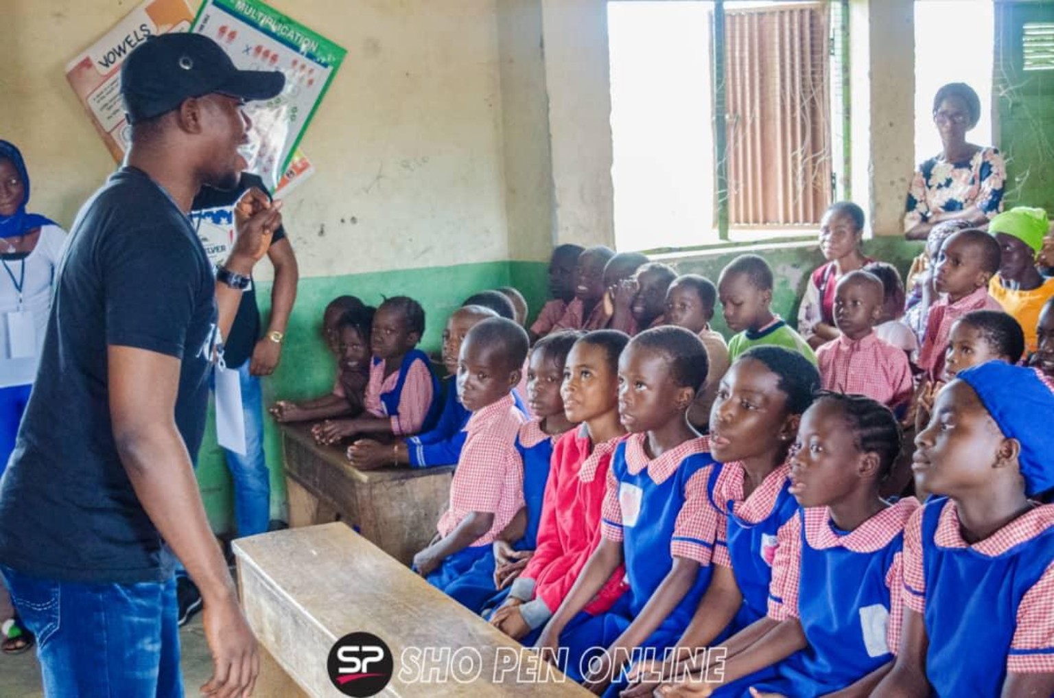 Speaking with students at a community visit