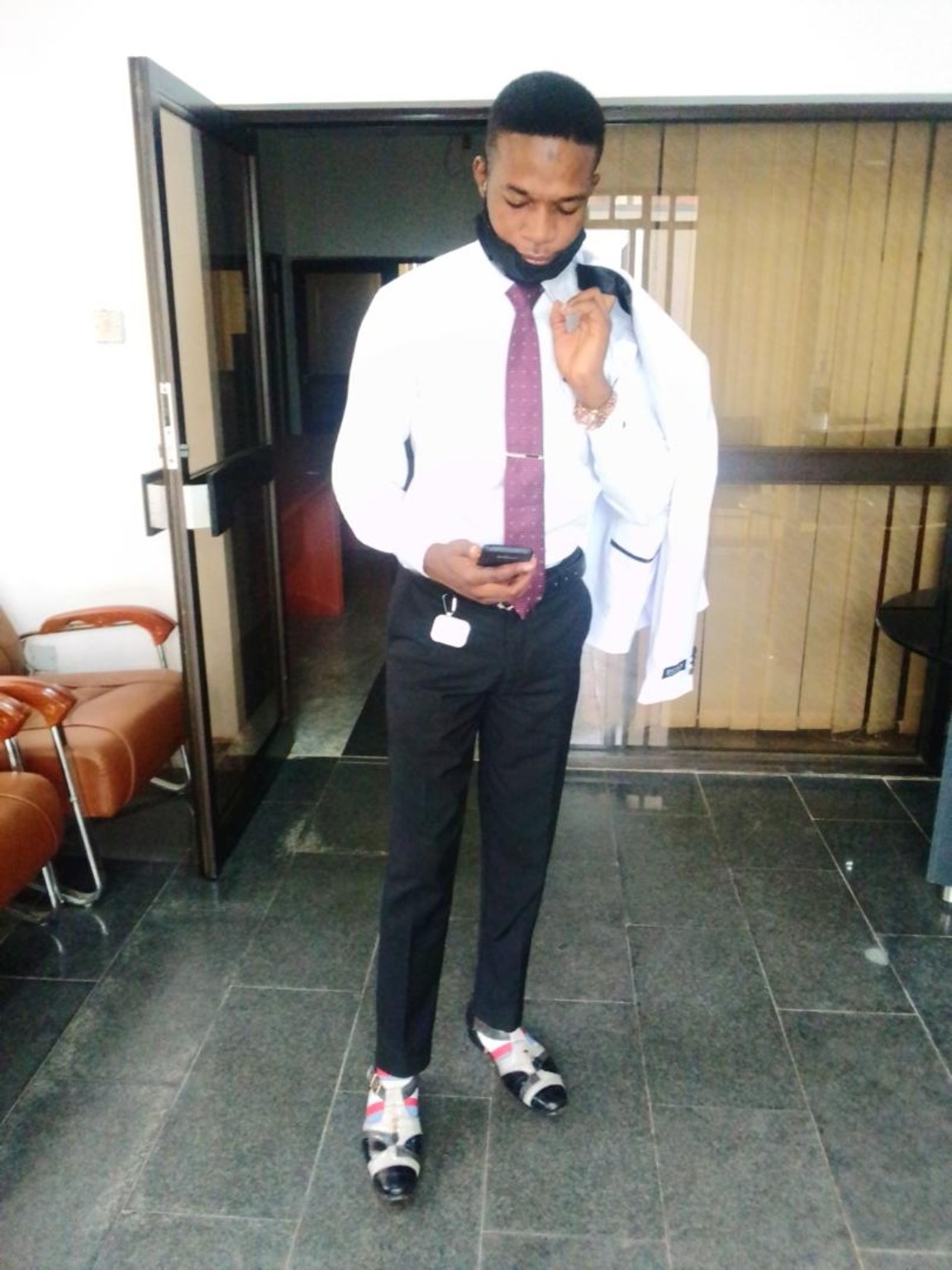 Standing indoors in formal attire